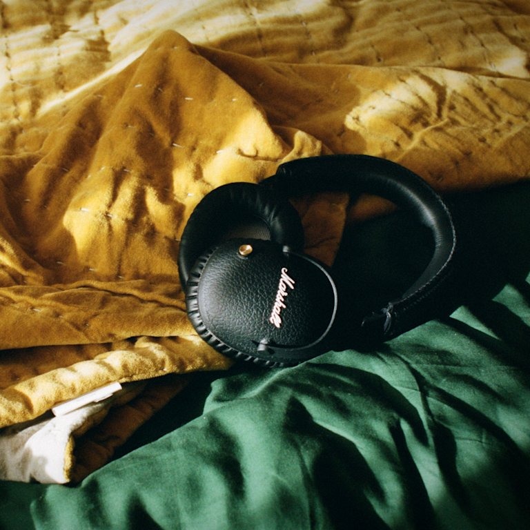 Marshall Monitor II A.N.C. Black Headphones placed on top of a green and yellow bed sheet