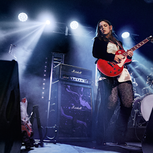 Ally Venable playing guitar live on stage