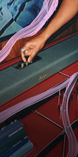 The Marshall Heston 120 placed on top of a stylish red shelf.