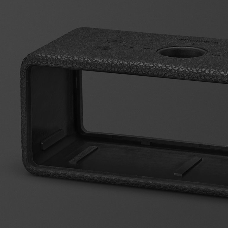 An Emberton III Black and Brass Sleeve, featuring a textured design, is shown against a dark background.