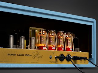 Close-up of the back panel of a Marshall 1959 BJA Artist Signature with glowing vacuum tubes and visible control labels.