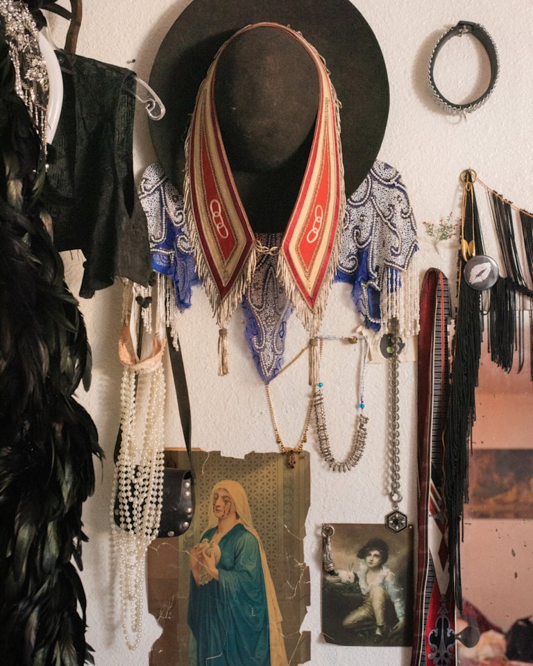 A room with hats, necklaces, and other items on the wall.