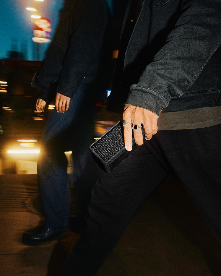 A person holding the Pitch Black Emberton III in hand