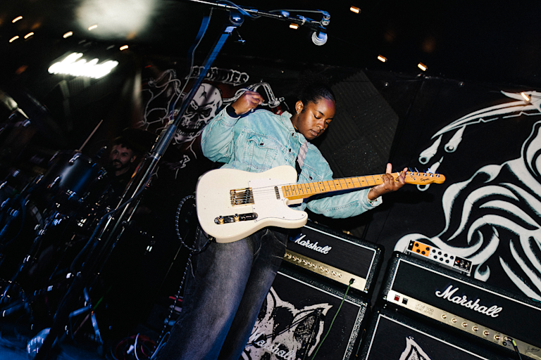 A person is playing the electric guitar