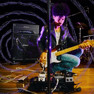 A musician playing his guitar on the Half stack