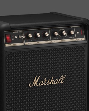 Close-up of a Marshall Bromley 450 speaker with control knobs and buttons on top and the Marshall logo on the front grille.