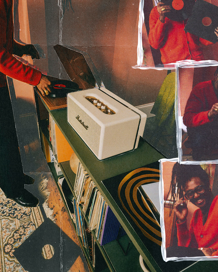 A person in a red shirt places a vinyl record on a turntable, next to Marshall Stanmore IV Cream speaker and vinyl records on a shelf.