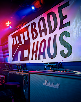 A Badehaus poster on a stage