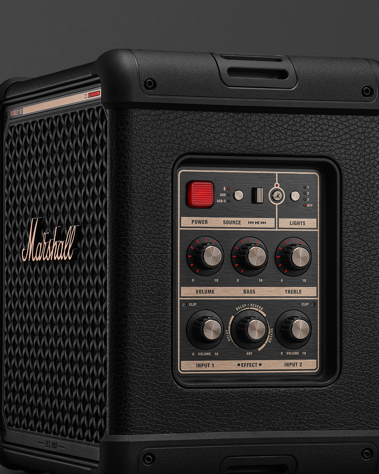 Close-up of a Marshall Bromley 150 Black and Brass showing control panel with knobs for volume, bass, treble, effect, power switch, and input jacks.