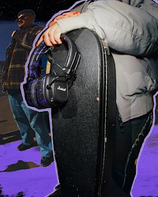 A person in grey jacket holds a black guitar case with Major V Hendrix Edition headphones attached.