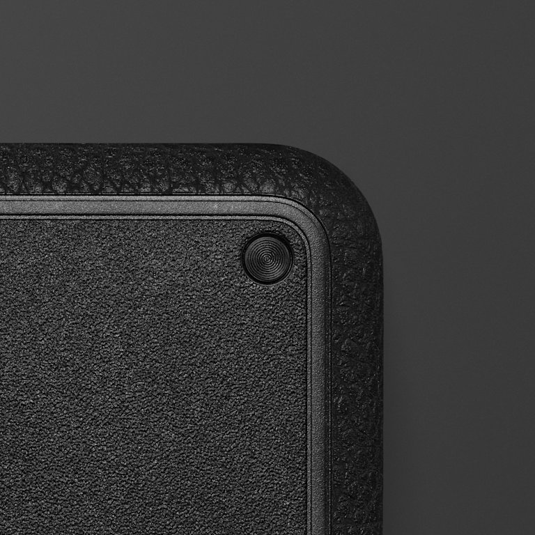 Close-up of the textured corner of a Heddon set against a dark background.