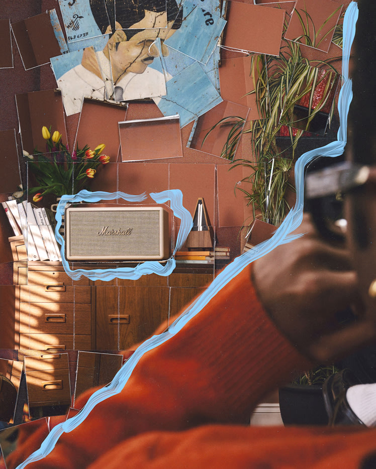 A person in orange sweater appears in the foreground; in the background are Marshall Stanmore IV Cream speaker, tulips in a vase adn books.