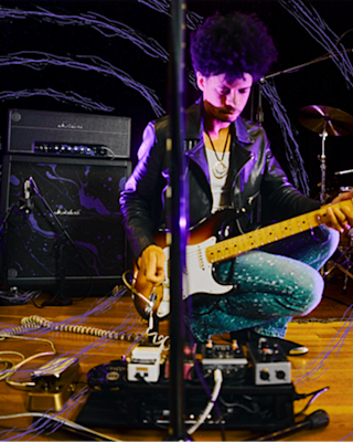 Zach Person setting up his guitar