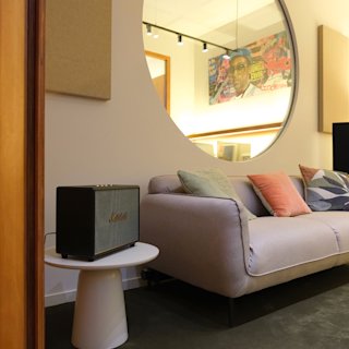 Inside the Combo Studio featuring a sofa and a speaker