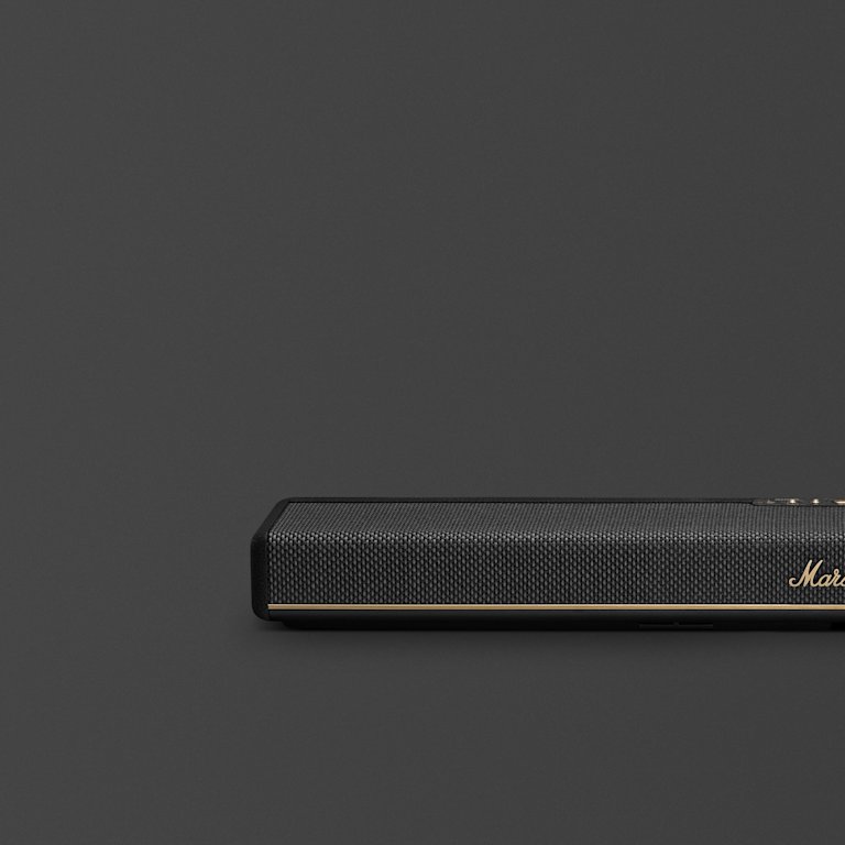 Marshall Heston 60 Black soundbar with a mesh front, is positioned in the lower right corner against a plain dark gray background.