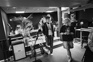 A group of people vibing in a cozy rehearsal space