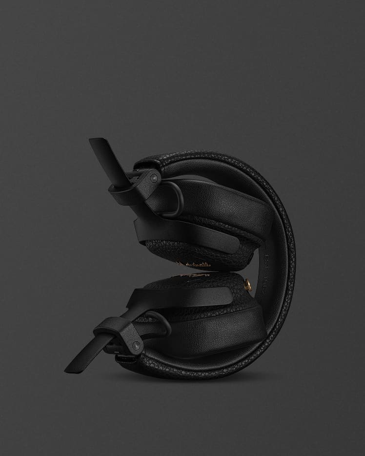 Folded Milton A.N.C. Black on-ear headphones against the dark background.