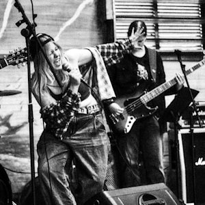 A black and white image of young people at a concert at Fryshuset