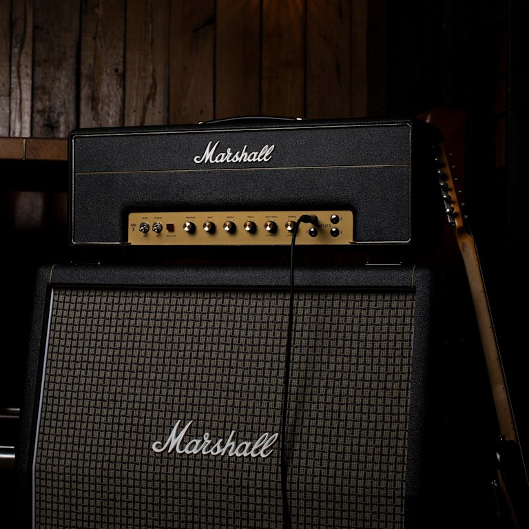 1987X Vintage Reissue Head on top of a Marshall angled amplifier.