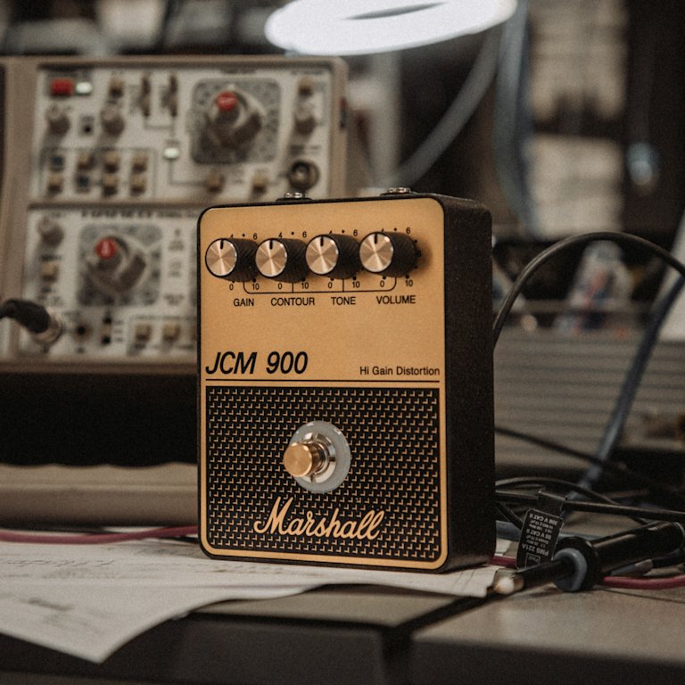 The Marshall JCM900 Overdrive pedal standing in a workshop desk.