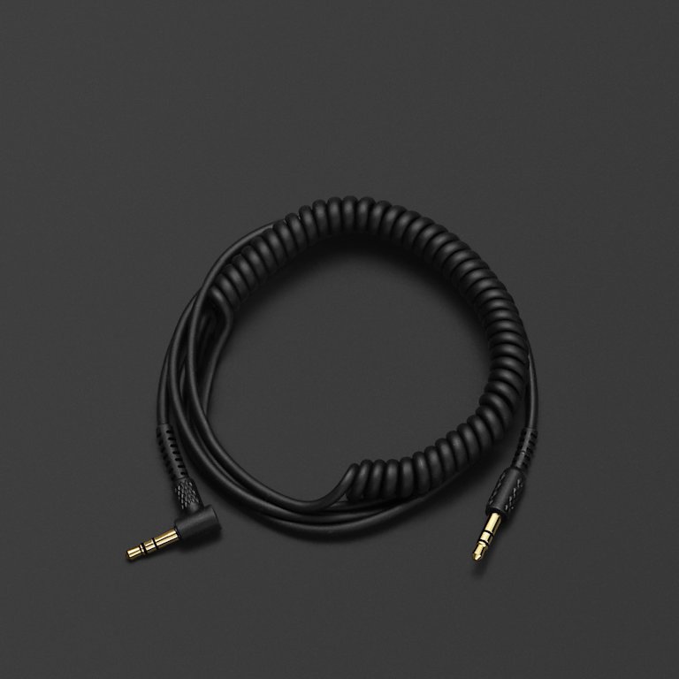 A Marshall black coiled audio cable on a black surface.