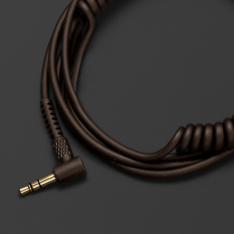 A Marshall headphone audio cable on a black surface.