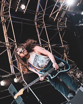 A person is playing the guitar on stage