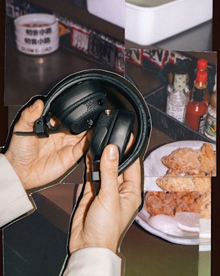 A person holding the folded Milton A.N.C. headphones