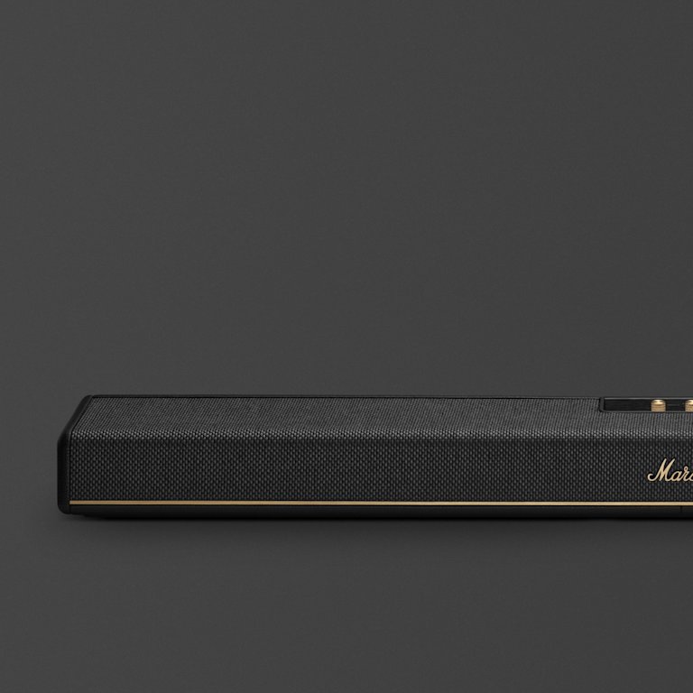 The Marshall Heston 120, a black rectangular soundbar with gold trim and "Marshall" on the front, stands out elegantly against a dark background.