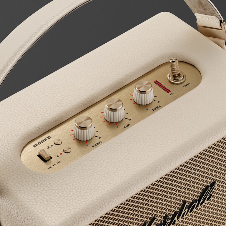 Marshall Kilburn III Cream portable Bluetooth speaker featuring a mesh grille, gold logo, top control knobs, and a leather carrying strap.