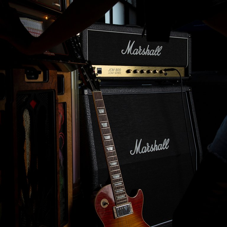 Marshall JCM800 2203 electric guitar and amp in a dark room.