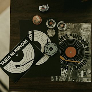 Women in vinyl vinyls and pins on a brown table