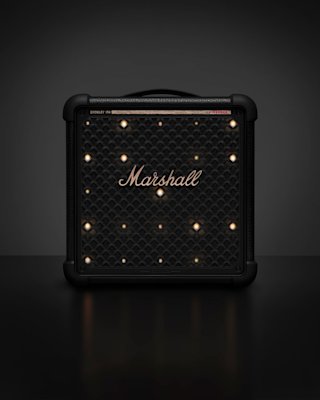 Bromley 150 integrated stage lights glowing through the front panel, resting on a black surface with a dark background.