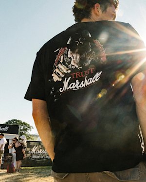 Person wearing a black Stax Reissue T-shirt, showing a big print on the back.
