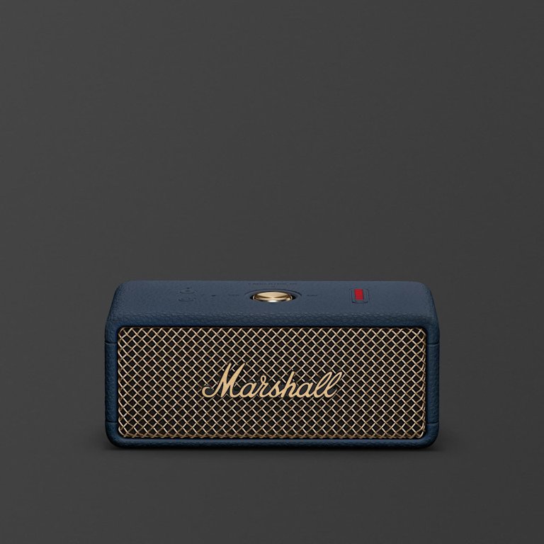 Marshall Emberton III Midnight Blue portable Bluetooth speaker, featuring a gold mesh front grille and navy blue casing, sits centered against a plain dark background.