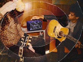 Guitarist tuning Acton III Hendrix Edition in the room.