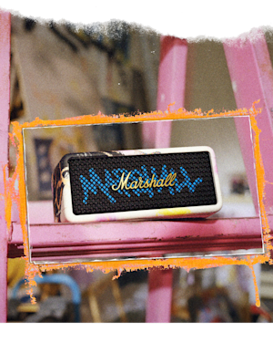 Emberton III Lunar New Year Edition 2026 portable speaker sits on a pink wooden ladder with a decorative orange border around the image.