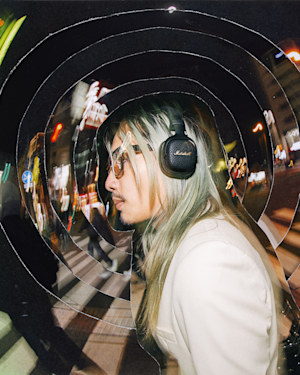 Gliiico listening to music using his Milton A.N.C. Headphones