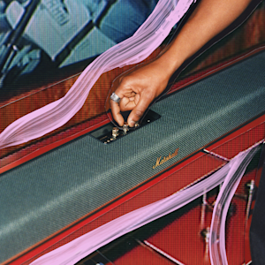 The Marshall Heston 120 placed on top of a stylish red shelf