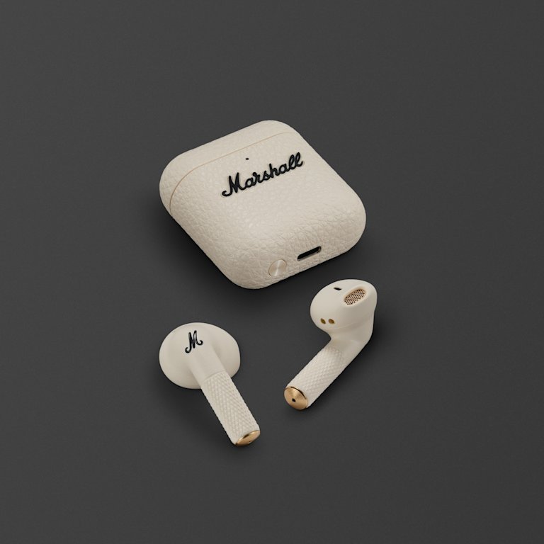 Marshall Minor IV Cream true wireless earbuds laying on a dark gray background.