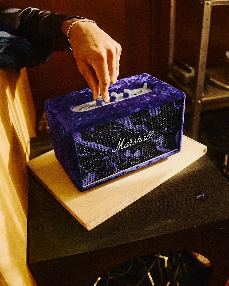 A hand adjusts the controls on a Acton III Marshall x Hendrix 60th Anniversary Edition speaker.