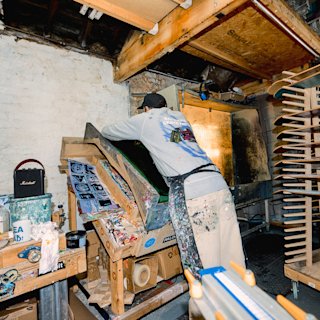 Stu smith in his art studio next to the Stockwell III Black and Brass