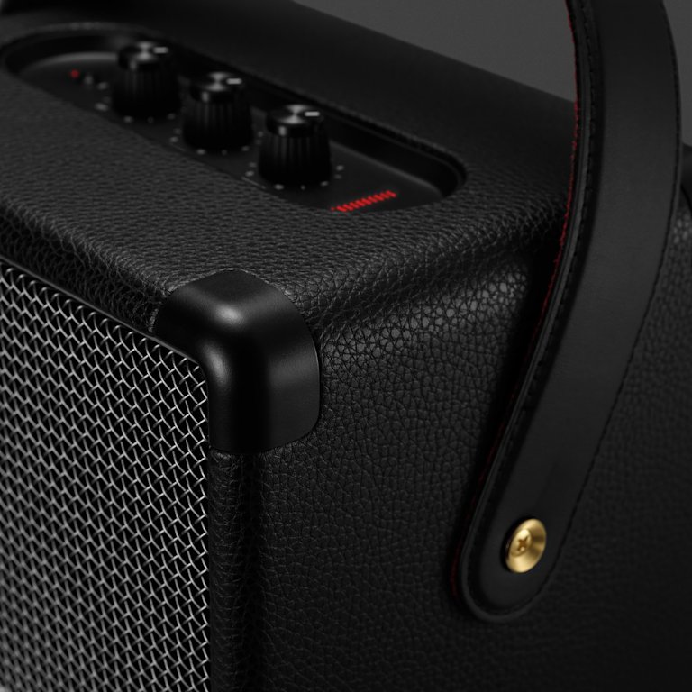 The Marshall Tufton Black Speaker has black control knobs a golden screw and a two colour handle, on the outside it is black and in the inside a velvet red.