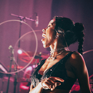 Nova Twins singing in a microphone