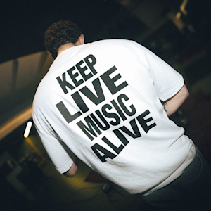 A person wearing the KLMA Tshirt in white