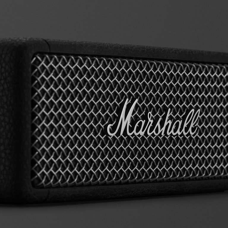 Marshall logo in front of the Marshall Emberton II Black and Brass.