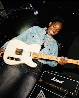 Ashaine White performing live on stage with Marshall amps