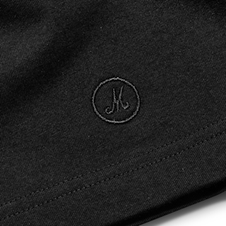 Zoomed in image of the Marshall symbol on the corner of the Hendrix Shadow T-shirt