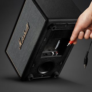 Connecting RCA audio cable into the back panel of Marshall Acton IV Black speaker.