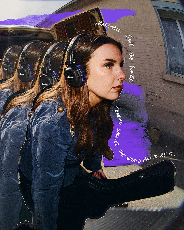 A woman wearing Major V Hendrix Edition headphones and a blue jacket, carrying a guitar case.